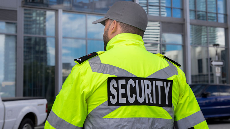 security worker in yellow high vis jacket
